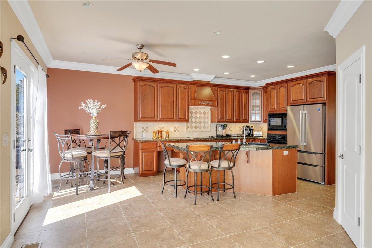 294 Sunrise Road, Unit 2 Copperopolis, CA 95228 - Photo 21 of 98 a kitchen with stainless steel appliances kitchen island granite countertop a refrigerator and microwave