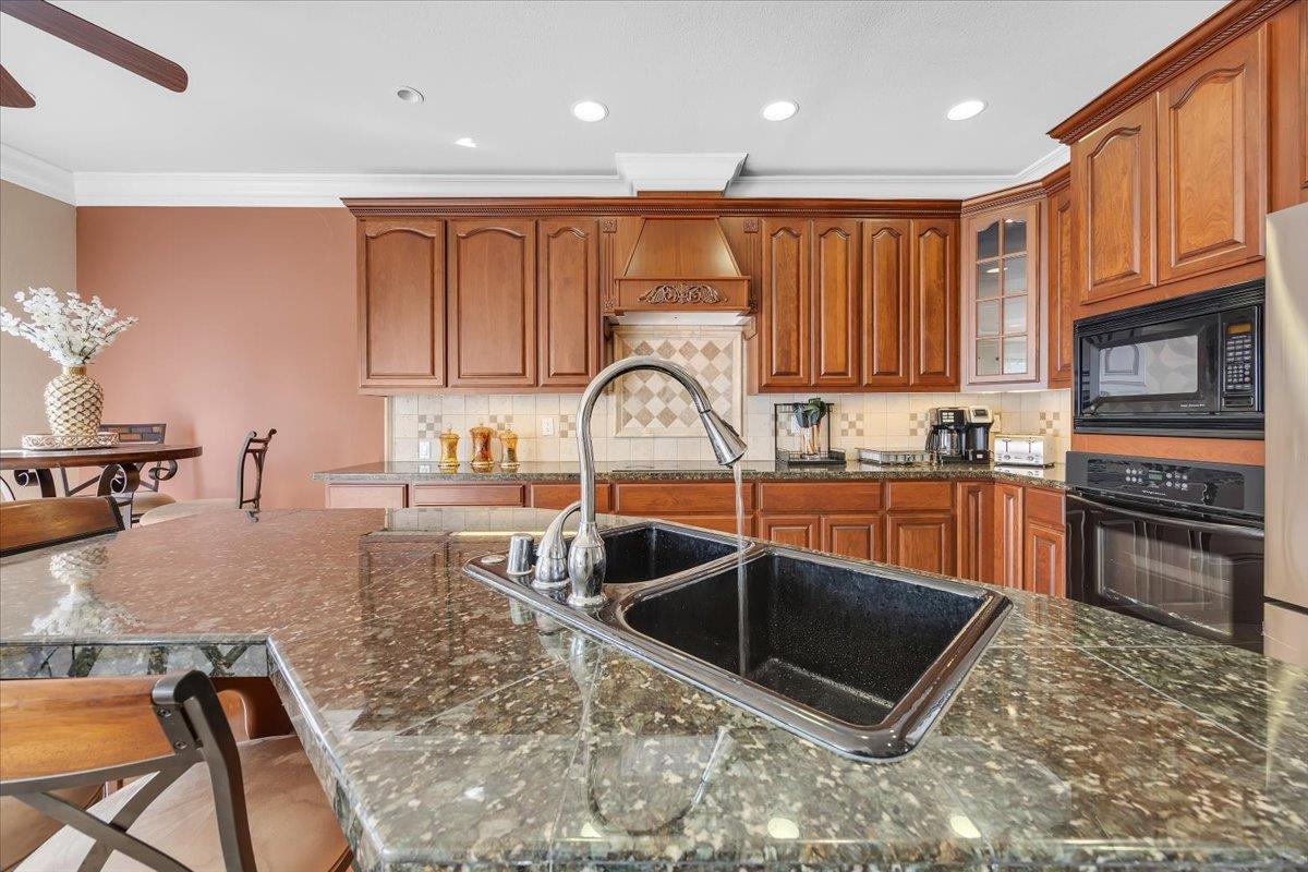 294 Sunrise Road, Unit 2 Copperopolis, CA 95228 - Photo 28 of 98 a kitchen with granite countertop a stove a sink and a microwave