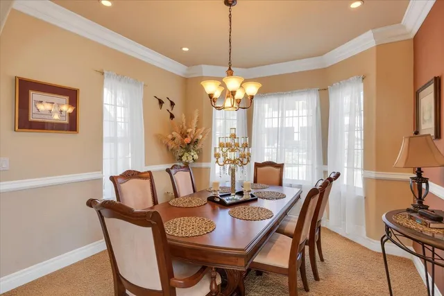 a bedroom with a bed and a lamp on dresser