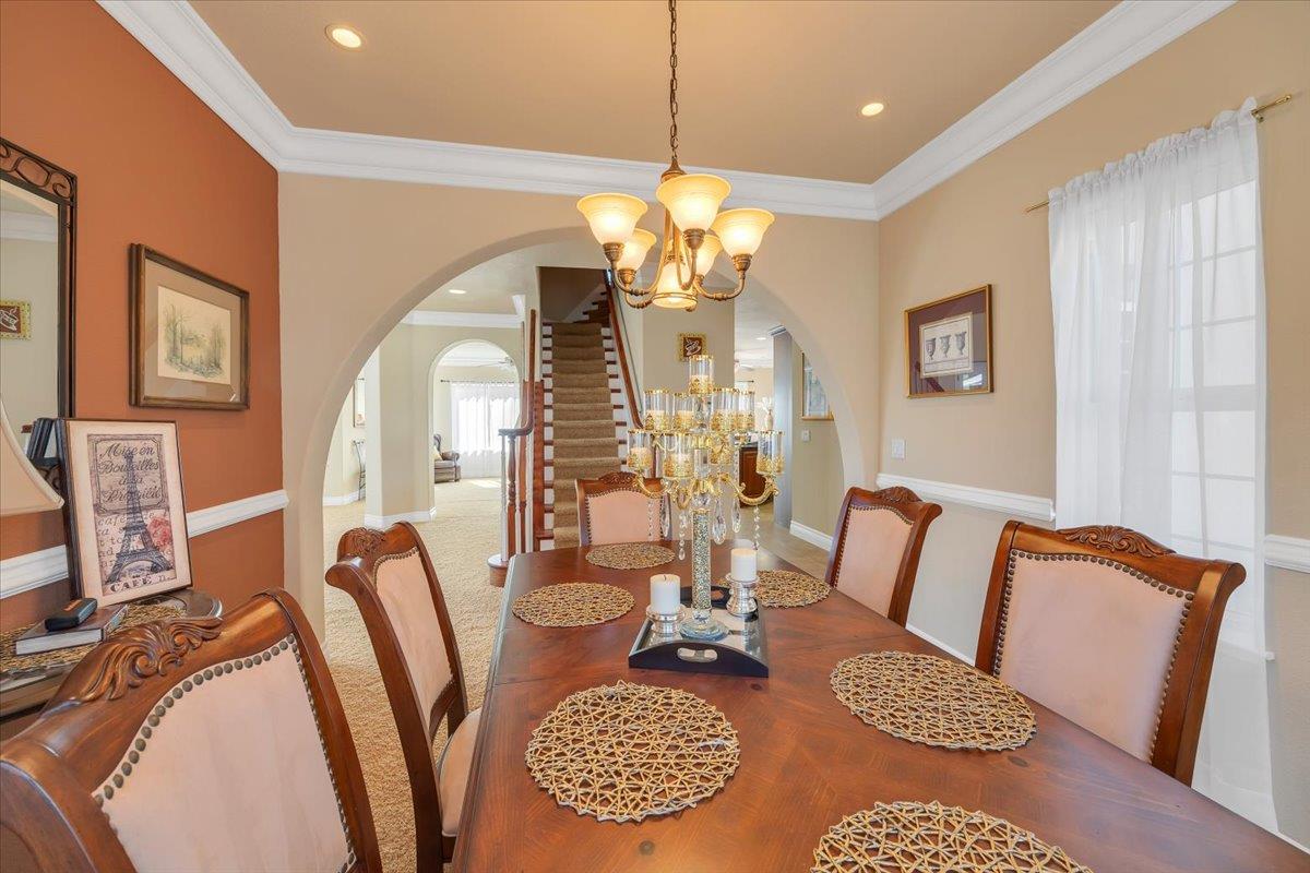 294 Sunrise Road, Unit 2 Copperopolis, CA 95228 - Photo 39 of 98 a living room with furniture a chandelier and a dining table