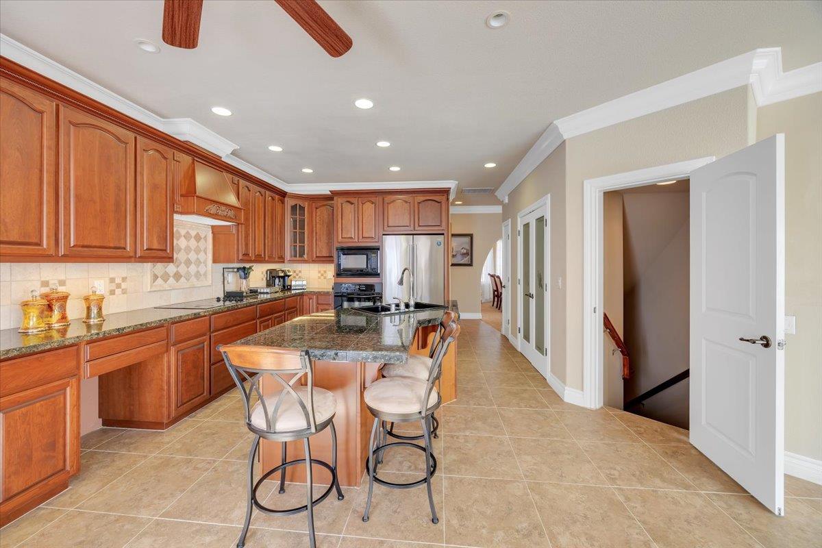 294 Sunrise Road, Unit 2 Copperopolis, CA 95228 - Photo 43 of 98 a kitchen with stainless steel appliances granite countertop a refrigerator and a stove top oven