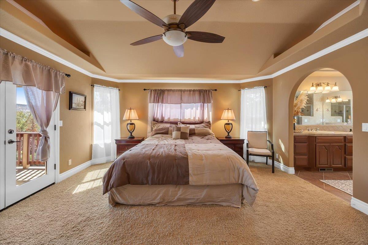 294 Sunrise Road, Unit 2 Copperopolis, CA 95228 - Photo 53 of 98 a spacious bedroom with a large bed and a chandelier