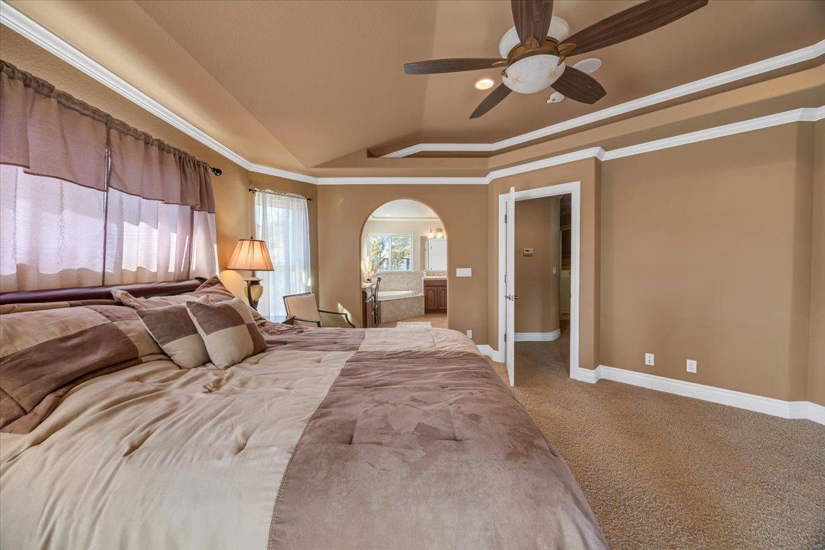294 Sunrise Road, Unit 2 Copperopolis, CA 95228 - Photo 57 of 98 a large bedroom with a large bed and a chandelier