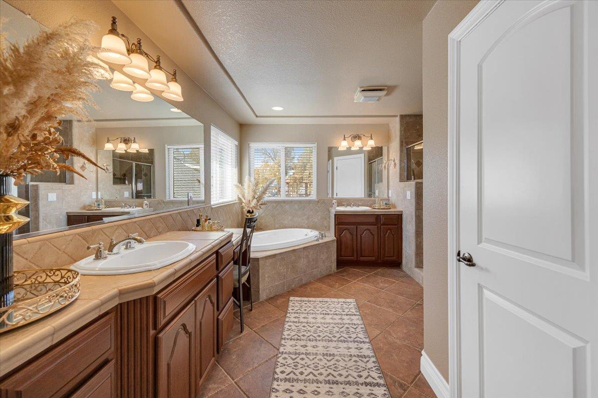 294 Sunrise Road, Unit 2 Copperopolis, CA 95228 - Photo 58 of 98 a spacious bathroom with a tub sink and mirror