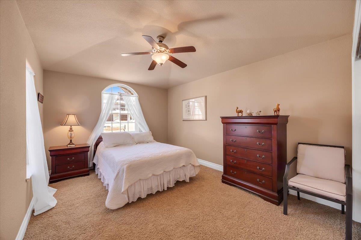 294 Sunrise Road, Unit 2 Copperopolis, CA 95228 - Photo 64 of 98 a bedroom with a bed and a lamp on dresser