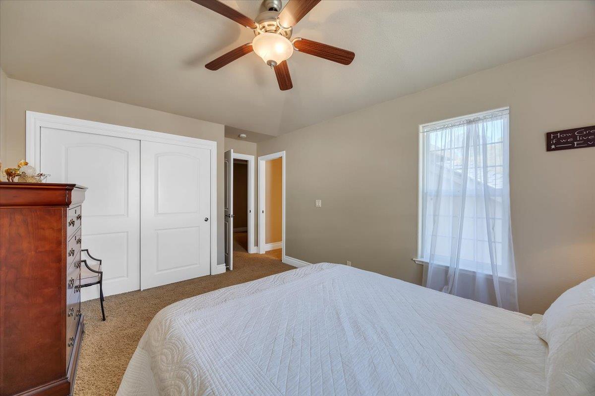 294 Sunrise Road, Unit 2 Copperopolis, CA 95228 - Photo 65 of 98 a bedroom with a bed and a chandelier