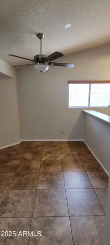 a view of a room with an empty space and a window