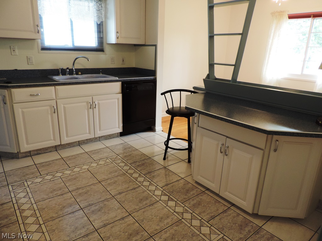 435 Center Road Bedford, OH 44146 - Photo 6 of 25 Updated Kitchen with white cabinetry, newer countertops, sink and custom ceramic flooring...