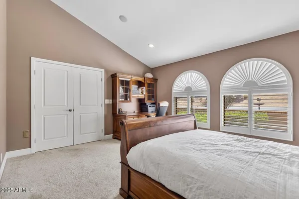 a bedroom with a large bed and a large window