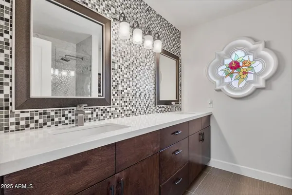 a bathroom with a sink a vanity and a mirror