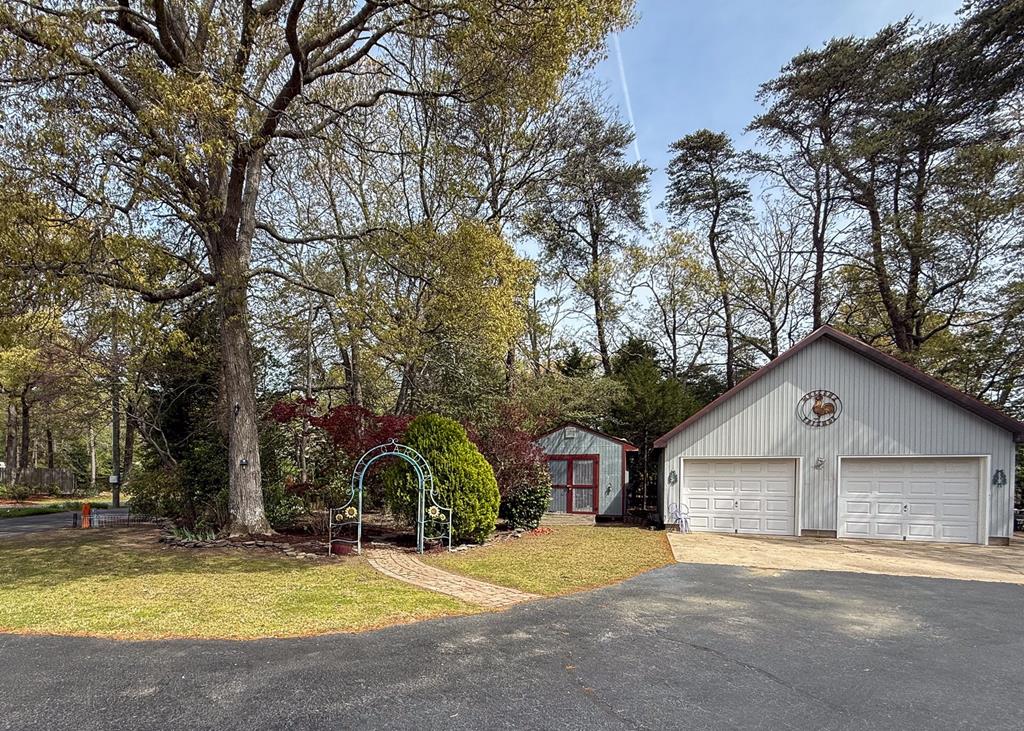 13581 Solitude Trail Machipongo, VA 23405 - Photo 30 of 51 a view of a house with a yard and large tree