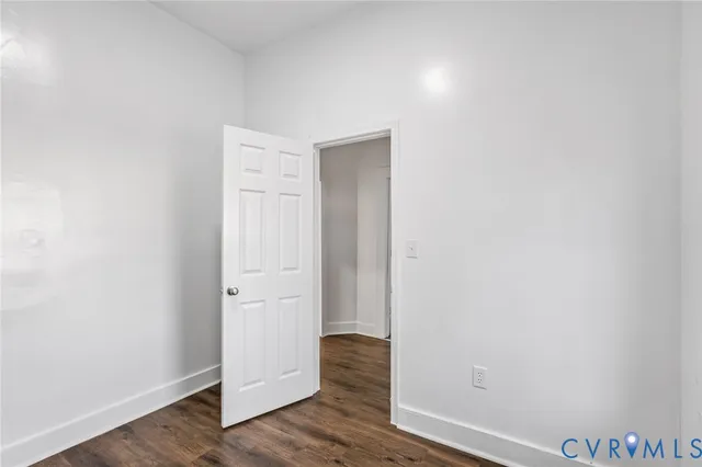 an empty room with wooden floor and closet