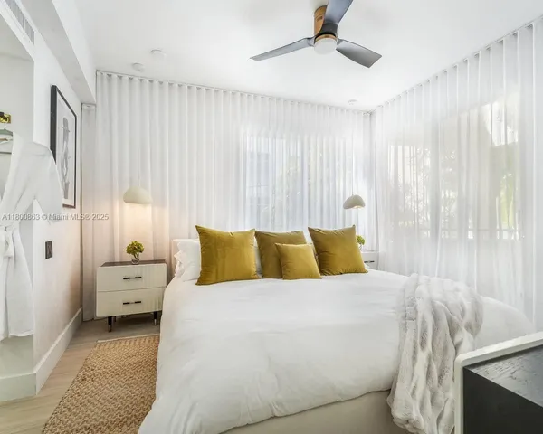 a large white bed in a white room