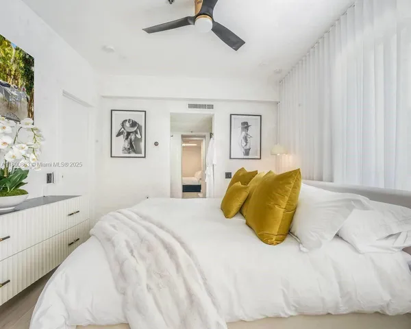 a bedroom with a large bed and a window