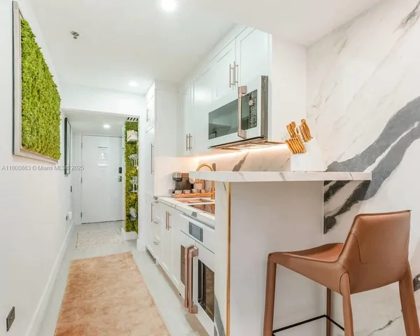 a kitchen with stainless steel appliances a stove a sink and a refrigerator