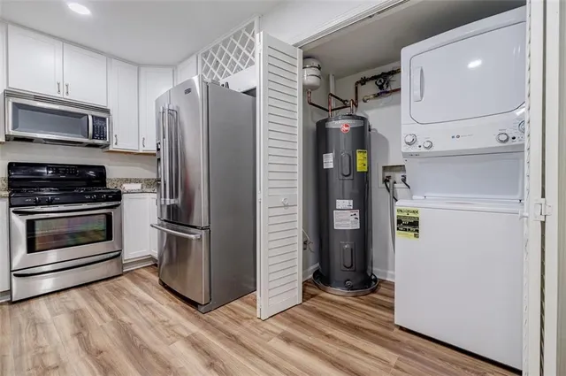 a kitchen with a refrigerator and a stove top oven