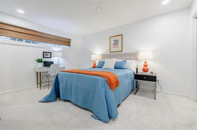 a bedroom with a bed and a lamp