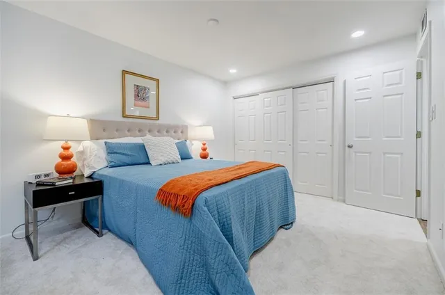 a bedroom with a bed and a painting on the wall