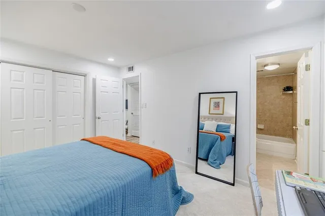 a bedroom with a bed and glass door