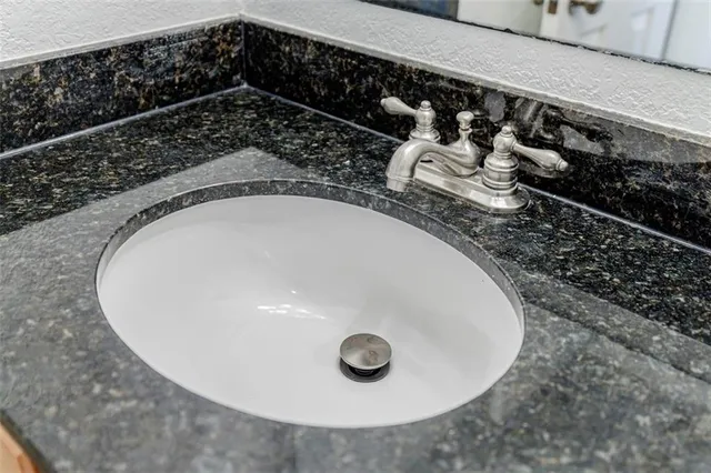 closeup of a sink with wooden floor
