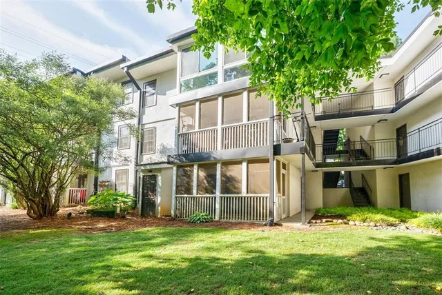 a view of a house with a yard and garden