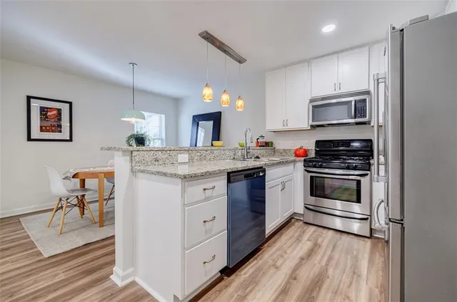 a kitchen with a stove oven and a refrigerator