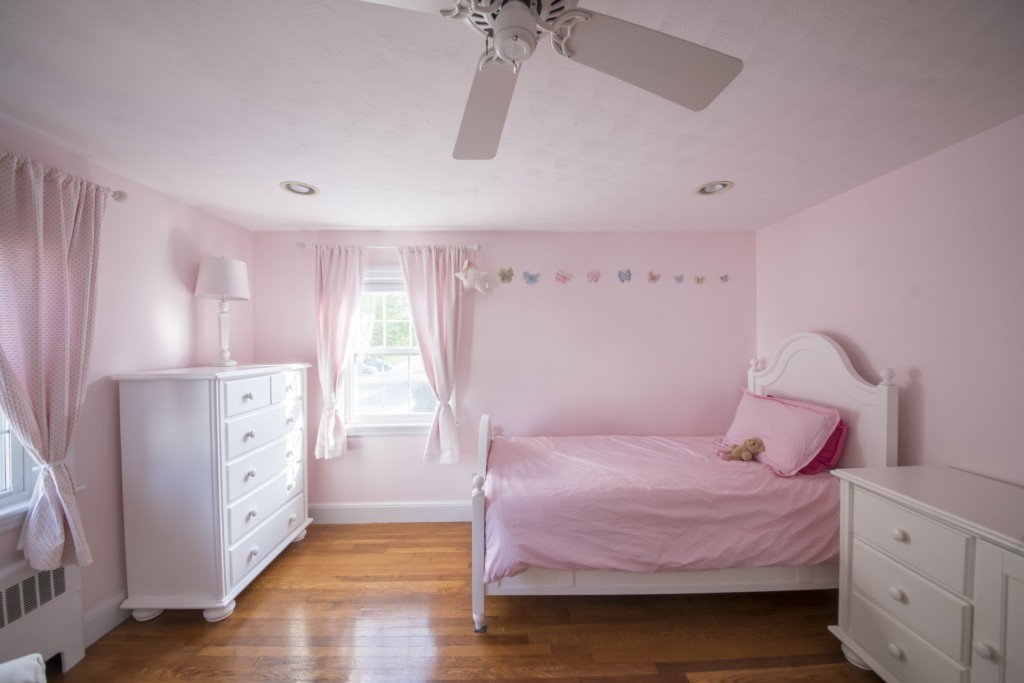 16 Latin Road Boston, MA 02132 - Photo 17 of 26 a bedroom with a bed and a chandelier