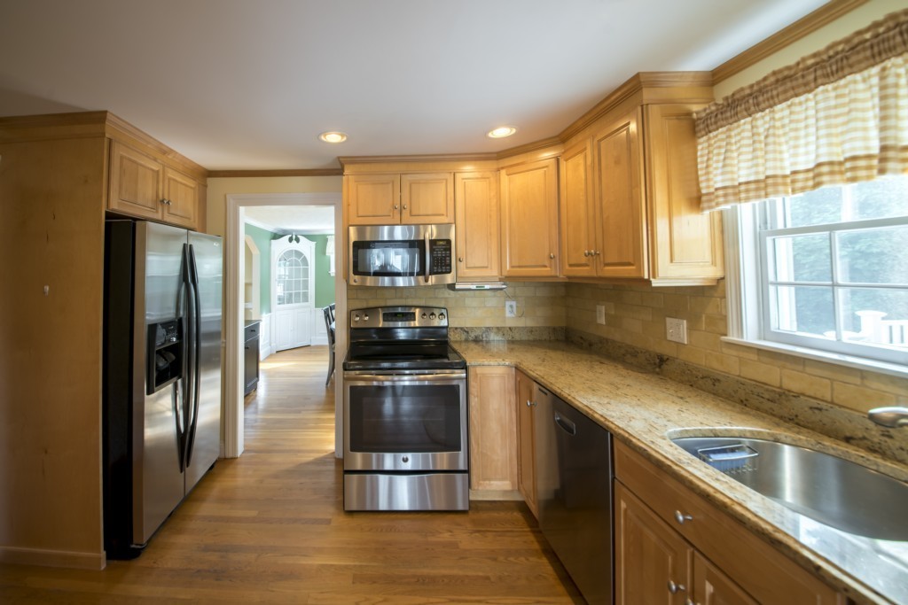 16 Latin Road Boston, MA 02132 - Photo 6 of 26 a kitchen with stainless steel appliances granite countertop a refrigerator sink and stove