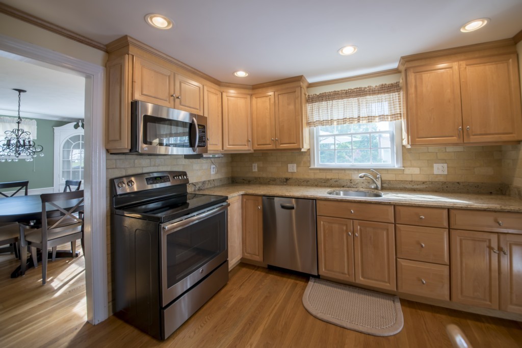 16 Latin Road Boston, MA 02132 - Photo 8 of 26 a kitchen with stainless steel appliances granite countertop a stove a sink and a microwave