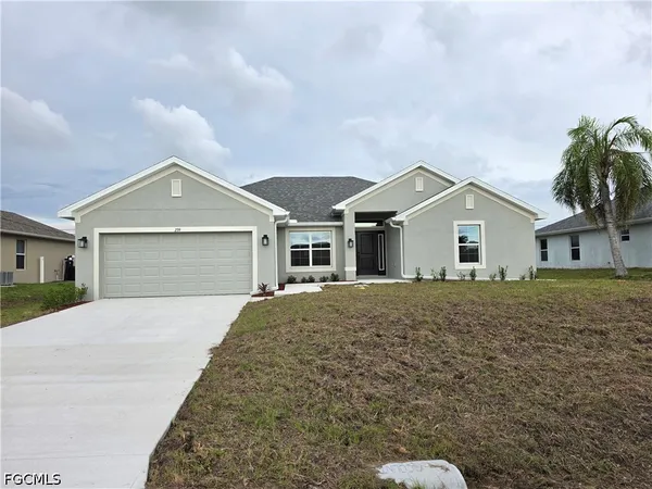 a front view of a house with a yard and garage
