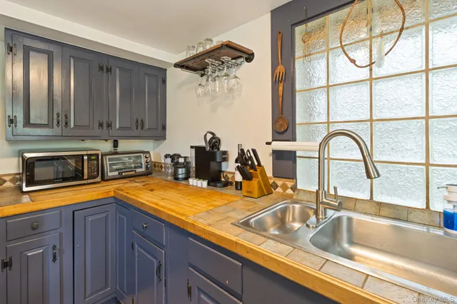 a kitchen with a sink and a large window