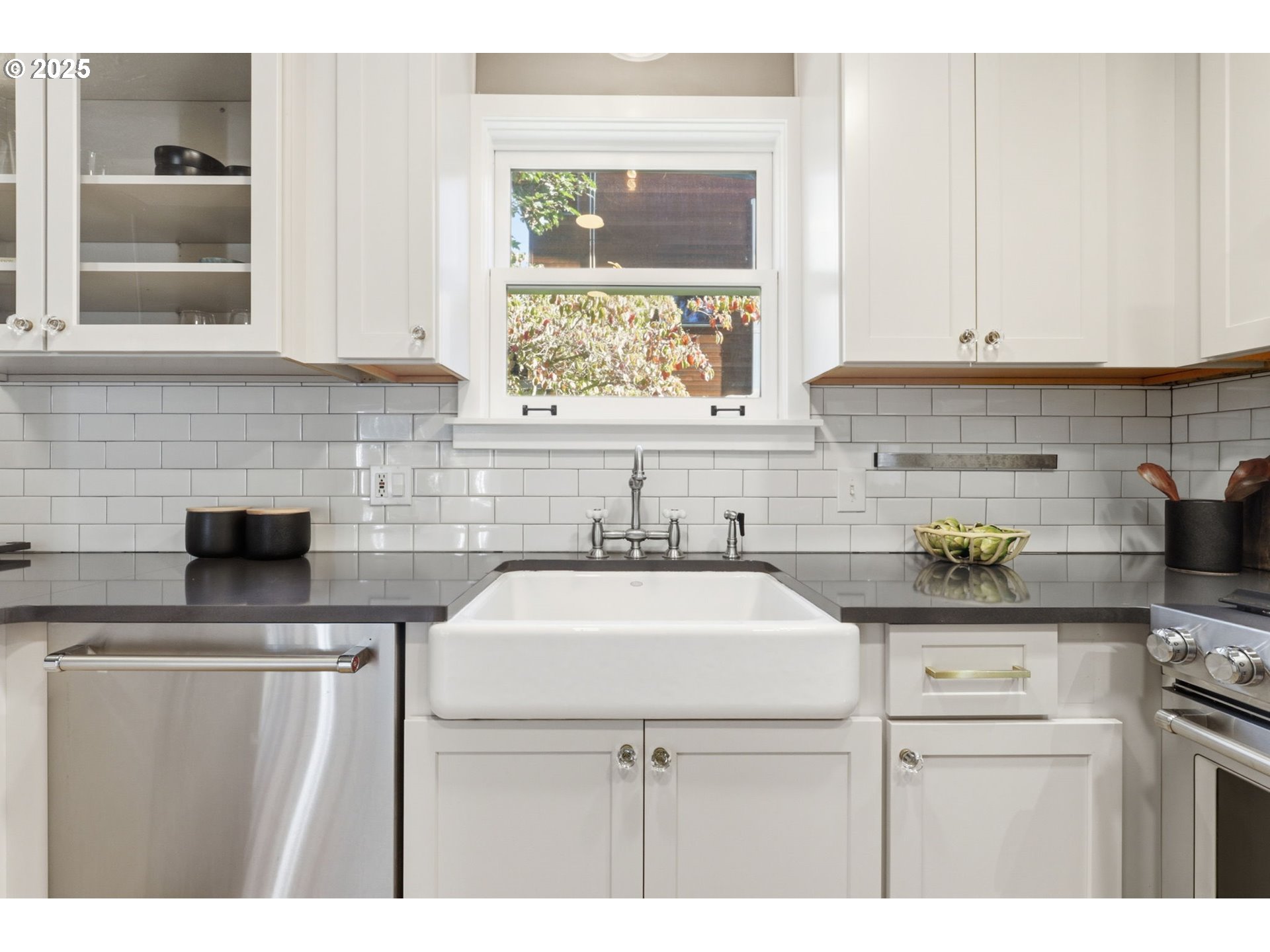 954 Northeast Emerson Street Portland, OR 97211 - Photo 21 of 47 a kitchen with kitchen island a sink stove and white cabinets