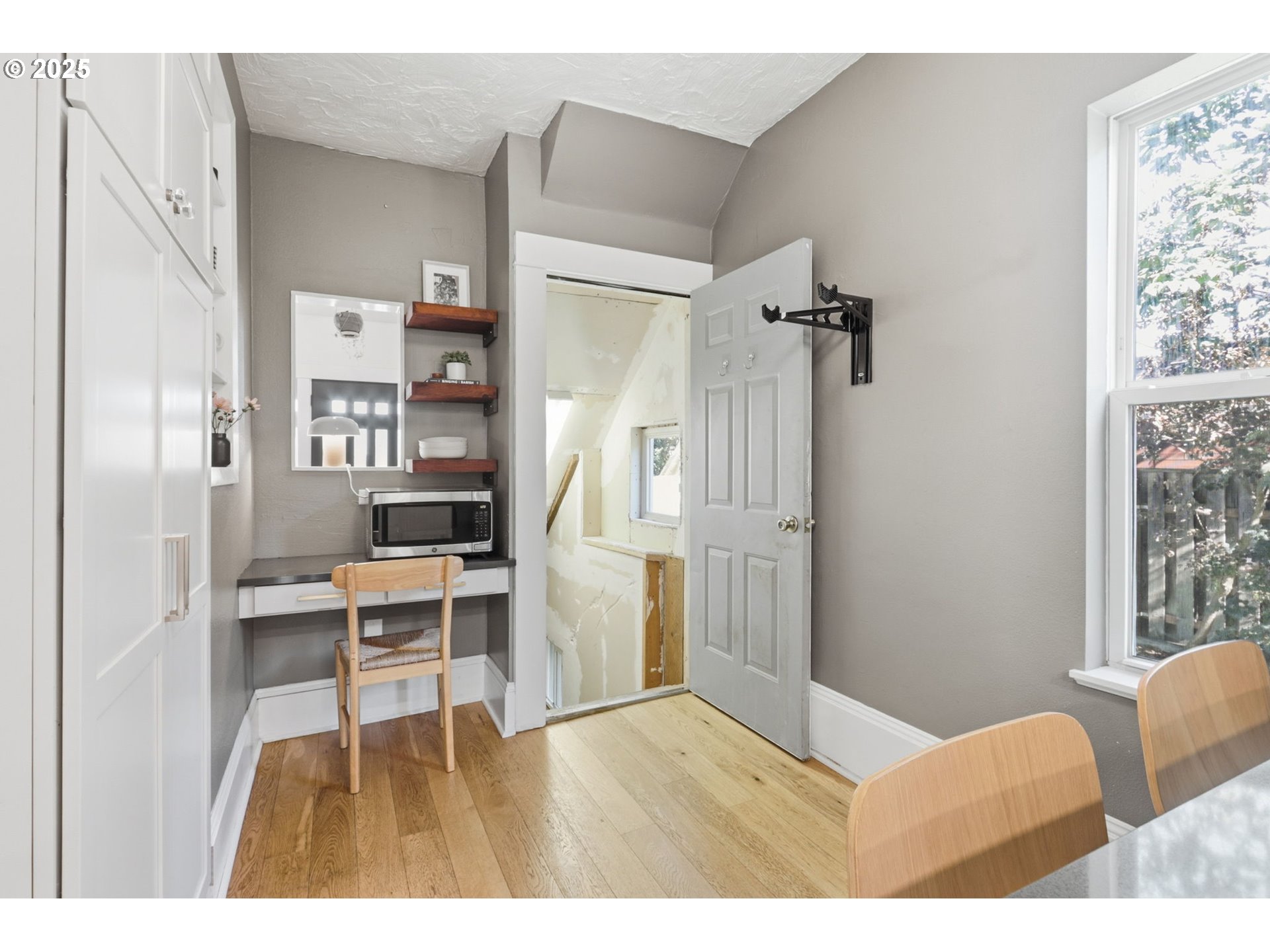 954 Northeast Emerson Street Portland, OR 97211 - Photo 30 of 47 a room with a window and a table chair