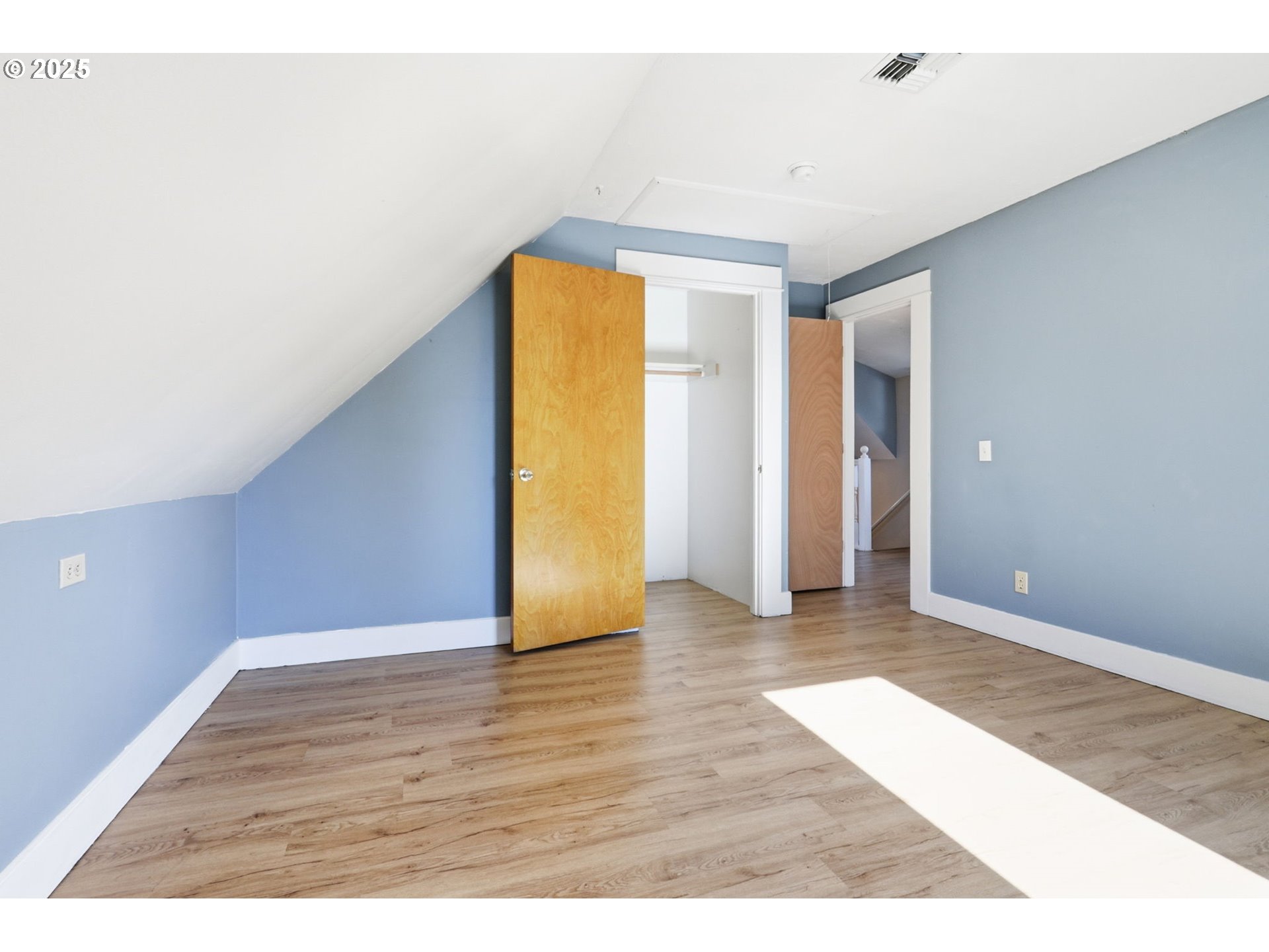954 Northeast Emerson Street Portland, OR 97211 - Photo 37 of 47 a view of an empty room with wooden floor