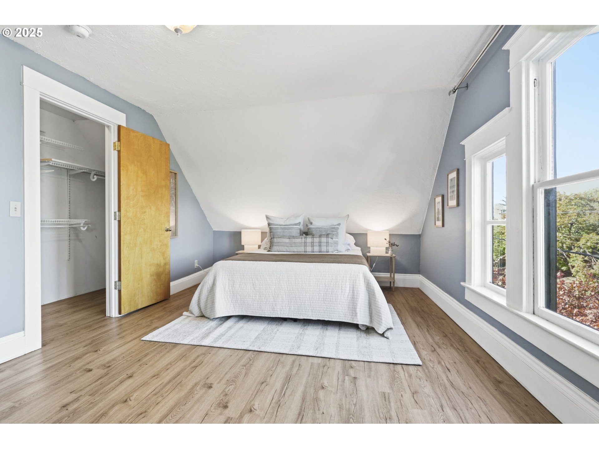 954 Northeast Emerson Street Portland, OR 97211 - Photo 41 of 47 a bedroom with a bed and wooden floor