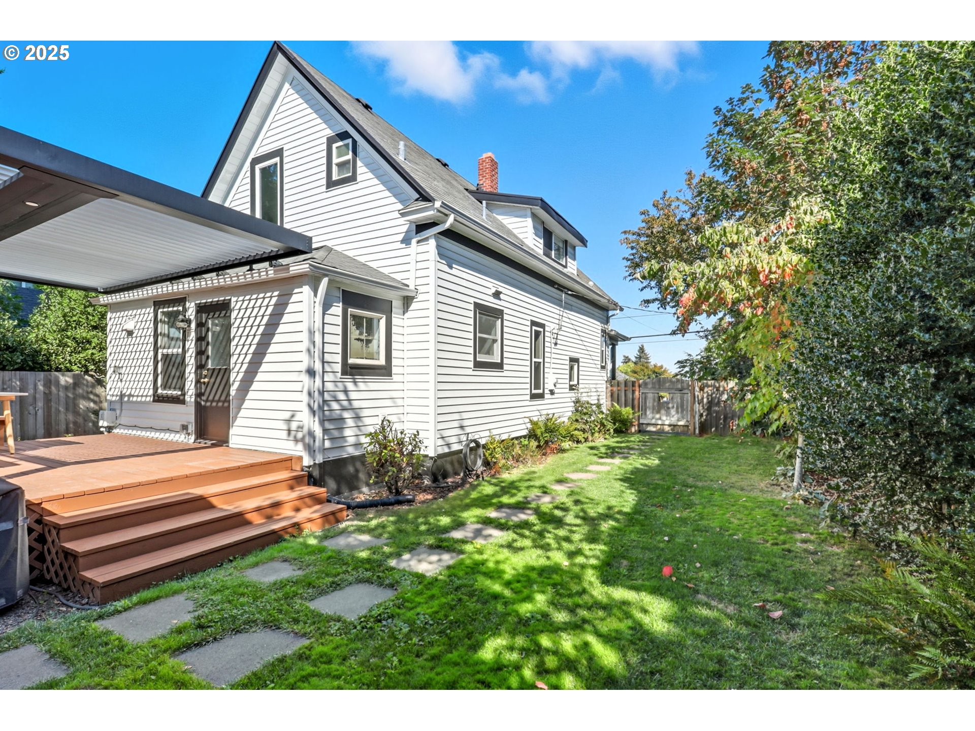 954 Northeast Emerson Street Portland, OR 97211 - Photo 45 of 47 a backyard of a house with table and chairs