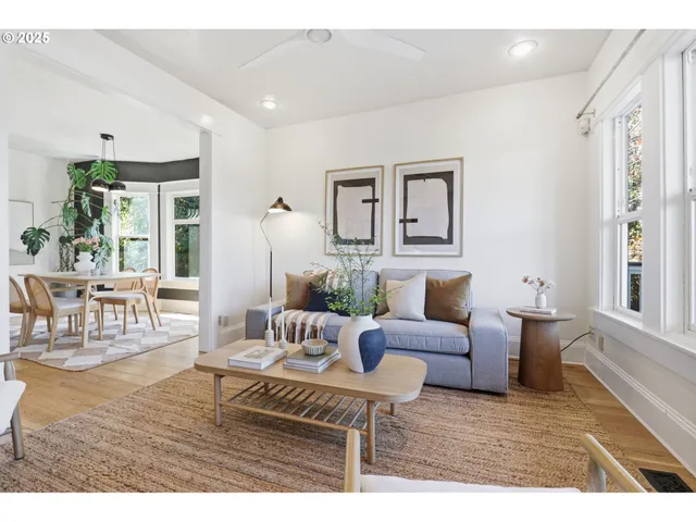 a living room with furniture wooden floor and a window