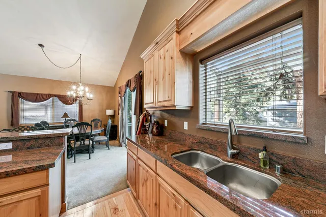 a kitchen filled counter top space a sink a stove and a window