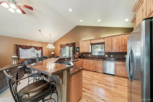 a kitchen with a table chairs refrigerator and cabinets