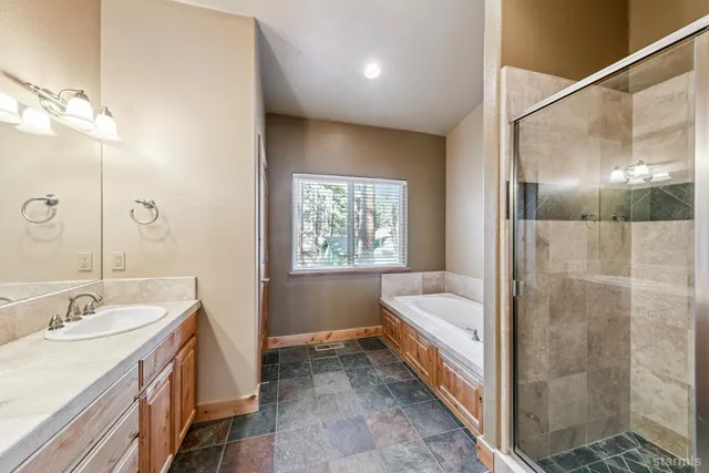 a bathroom with a double vanity sink and a bathtub