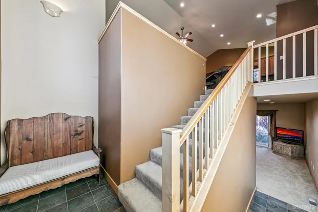 a hallway with stairs and a couch