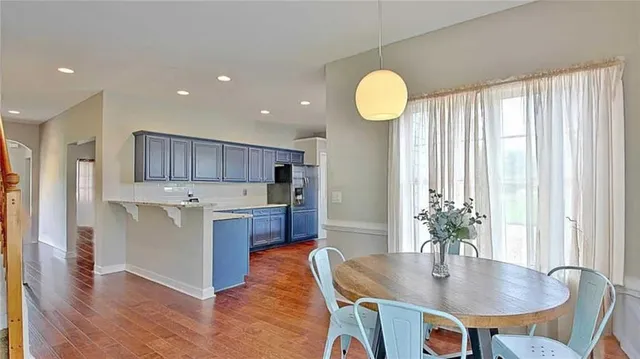 a view of a room with wooden floor door and windows