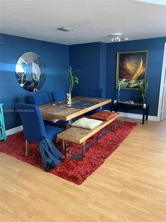 a living room with furniture a dining table and a flat screen tv