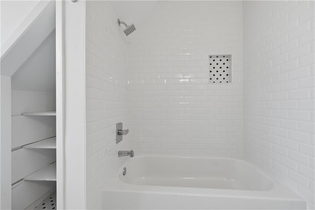 2415 Charleston Oaks Lane Decatur, GA 30030 - Photo 21 of 55 a close up of a bathtub in a bathroom
