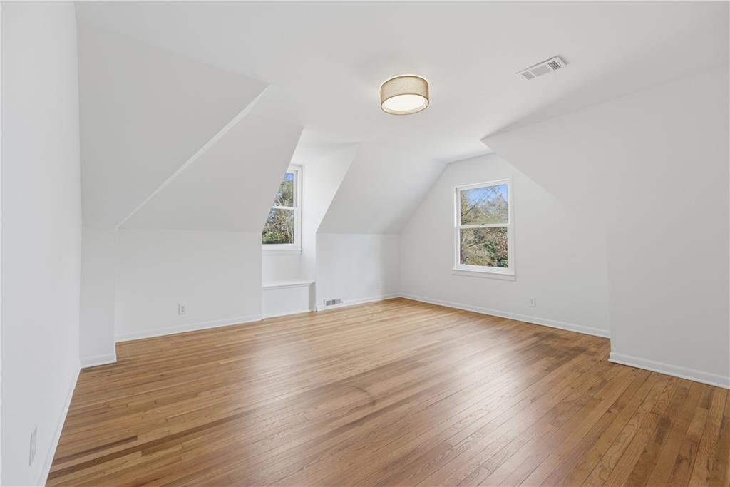 2415 Charleston Oaks Lane Decatur, GA 30030 - Photo 22 of 55 an empty room with wooden floor and windows