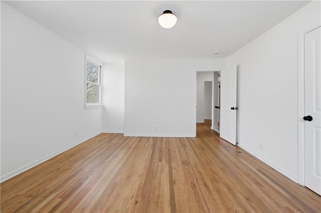 2415 Charleston Oaks Lane Decatur, GA 30030 - Photo 27 of 55 a view of an empty room with wooden floor and a window