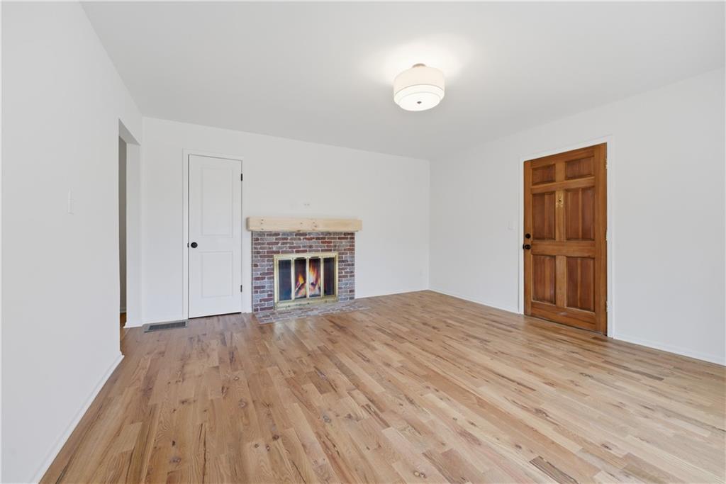 2415 Charleston Oaks Lane Decatur, GA 30030 - Photo 7 of 55 a view of empty room with wooden floor and fan