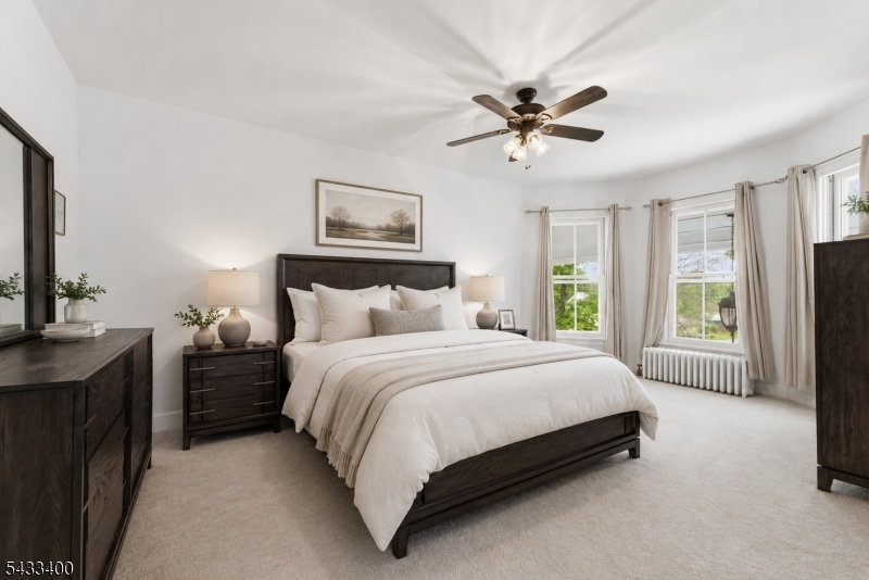 61 New Street Hampton, NJ 08827 - Photo 28 of 45 a spacious bedroom with a bed a couch and a window