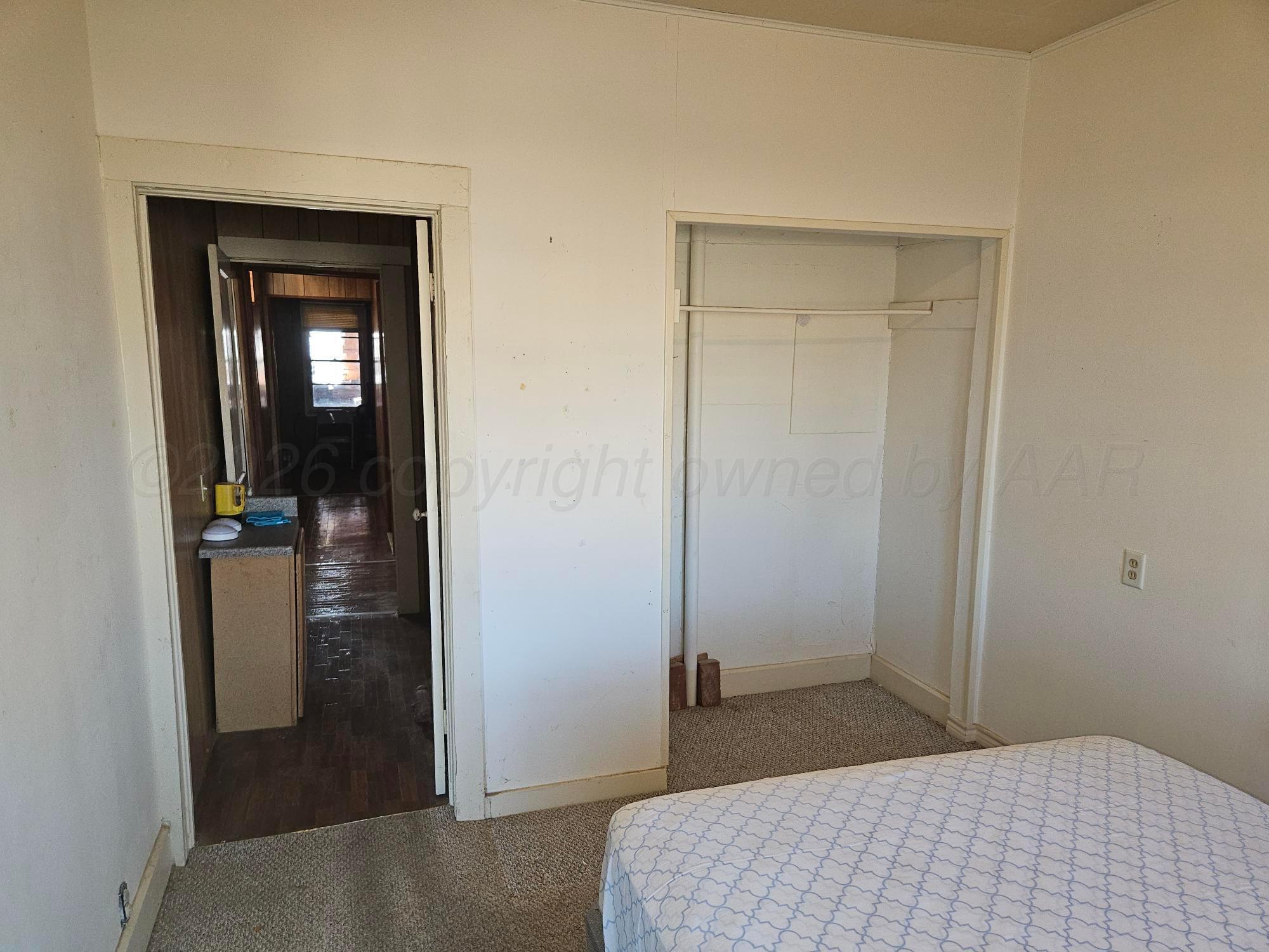 201 Oak Avenue Panhandle, TX 79068 - Photo 27 of 44 a bedroom with a bed and a mirror