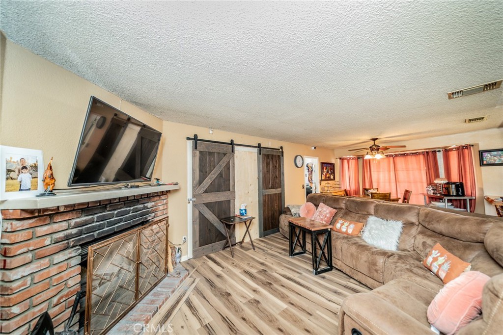 4637 Luna Road Phelan, CA 92371 - Photo 12 of 43 a living room with furniture and a flat screen tv